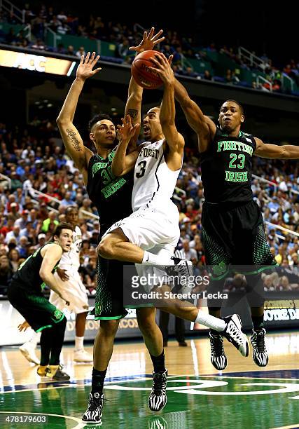 Zach Auguste of the Notre Dame Fighting Irish and teammate Demetrius Jackson try to stop Coron Williams of the Wake Forest Demon Deacons during the...