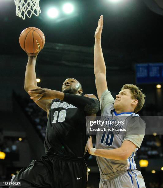 Kadeem Batts of the Providence Friars drives to the basket past Grant Gibbs of the Creighton Bluejays during their game at CenturyLink Center on...