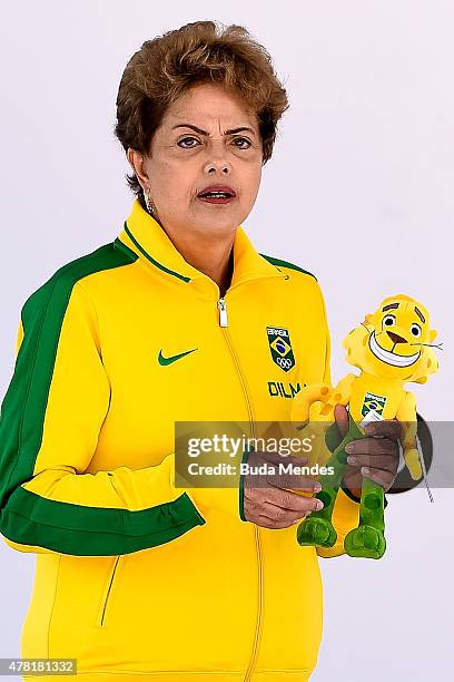 President Dilma Rousseff of Brazil holds a doll of Ginga, the Brazilian national Olympic team's new mascot, after being introduced by the Brazilian...