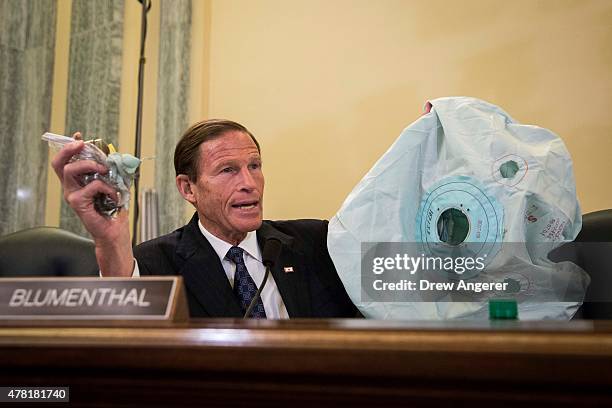 Sen. Richard Blumenthal holds up an airbag and inflator during a Senate Commerce, Science, and Transportation Committee hearing entitled ÒUpdate on...