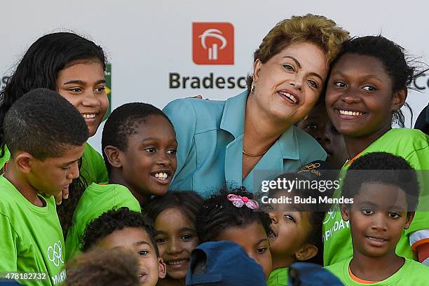 Brazil's President Dilma Rousseff is greeted by children during the Olympic Day celebration and presentation of Brazilian national teams mascot Ginga...