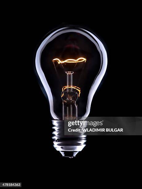 light bulb - incandescent bulb stock-fotos und bilder