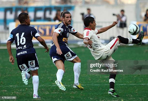 Nicolas Ayr of Sporting Cristal fights for the ball with Raul Ruidiaz of Universitario during a match between Sporting Cristal and Universitario as...