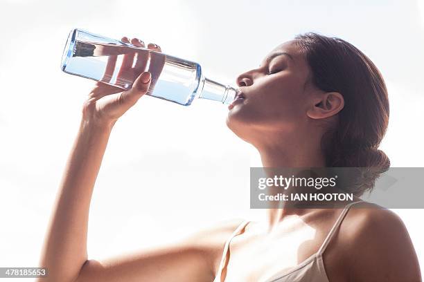 woman drinking water - woman drinking water from bottle stock-fotos und bilder