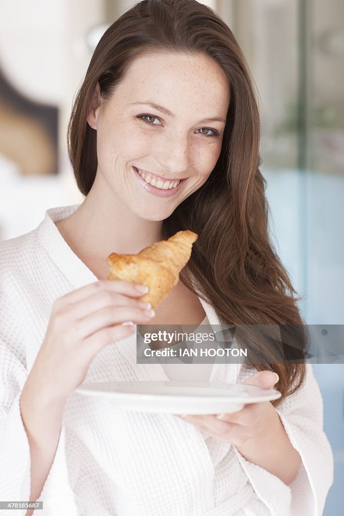 Young woman eating a pastry