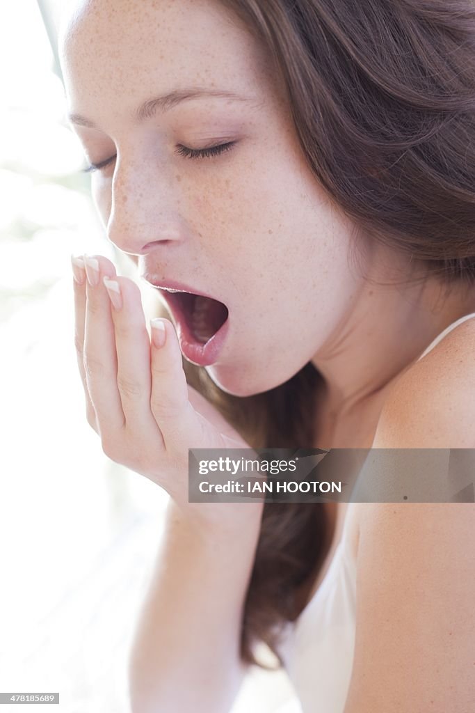 Young woman yawning