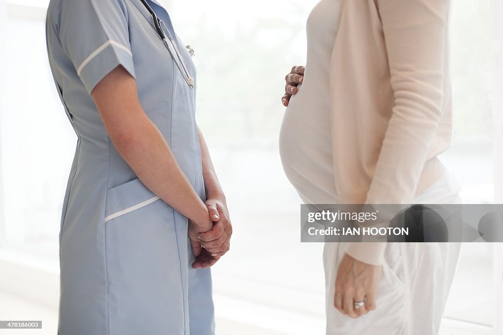 Pregnant woman and nurse