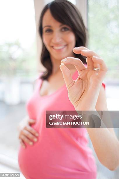 pregnant woman with supplement - folic acid stock pictures, royalty-free photos & images