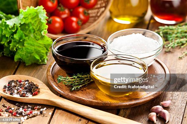 vinaigrette ingredients on rustic wood table - vinegar stockfoto's en -beelden