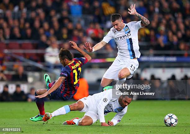 Neymar of Barcelona collides with Joleon Lescott and Aleksandar Kolarov of Manchester City during the UEFA Champions League Round of 16, second leg...