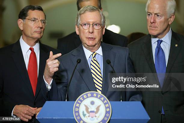 Senate Majority Leader Mitch McConnell talks to reporters with Sen. John Barrasso and Senate Majority Whip John Cornyn after the weekly Republican...