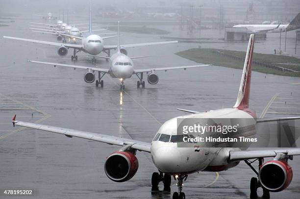 Domestic and International flights lined up for take-off at Chhatrapati Shivaji International Airport on June 23, 2015 in Mumbai, India. Due to heavy...