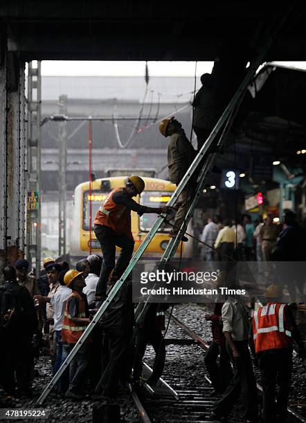 Repair work underway as overhead wire snapped near Dadar railway station on June 23, 2015 in Mumbai, India. Trains on western line are delayed by 15...