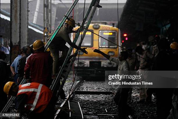 Repair work underway as overhead wire snapped near Dadar railway station on June 23, 2015 in Mumbai, India. Trains on western line are delayed by 15...