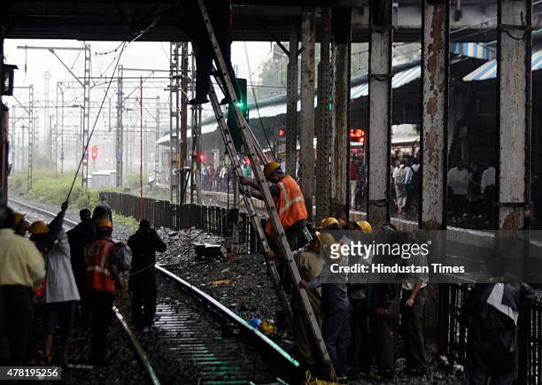 Repair work underway as overhead wire snapped near Dadar railway station on June 23, 2015 in Mumbai, India. Trains on western line are delayed by 15...