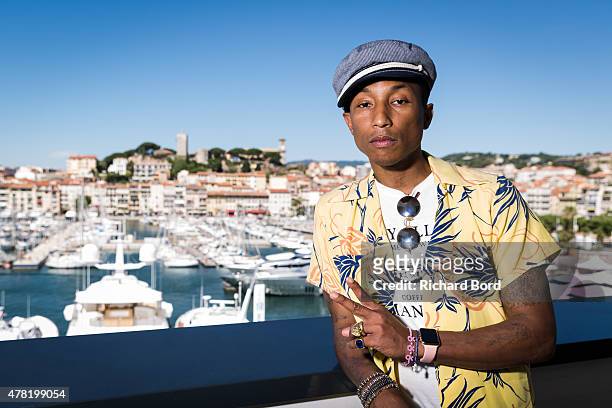 Pharrell Williams poses on the balcony of the Palais des Festivals after the iHeart Seminar during the Cannes Lions International Festival of...