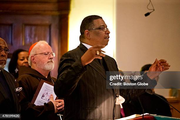 Rev. Dr Gregory G. Groover leading the congregation in a song written by Presbyterian minister, Csrolyn Winfrey Gillette about the Charleston...