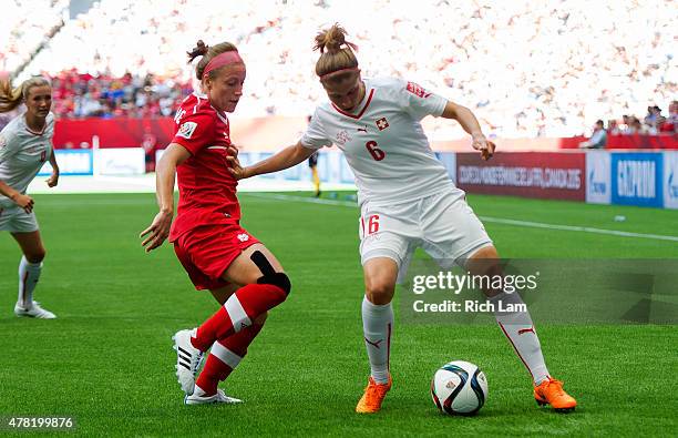 Josee Belanger of Canada tries to check the ball off of Selina Kuster of Switzerland during the FIFA Women's World Cup Canada 2015 Round of 16 match...