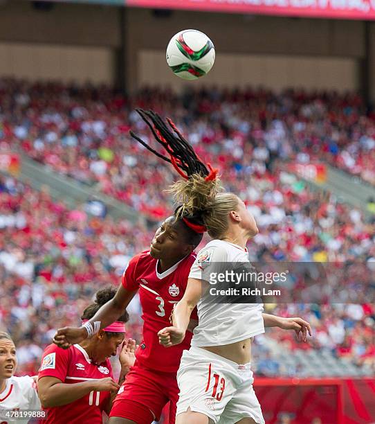 Kadeisha Buchanan of Canada and Ana-Maria Crnogorcevic of Switzerland go up for a loose ball during the FIFA Women's World Cup Canada 2015 Round of...