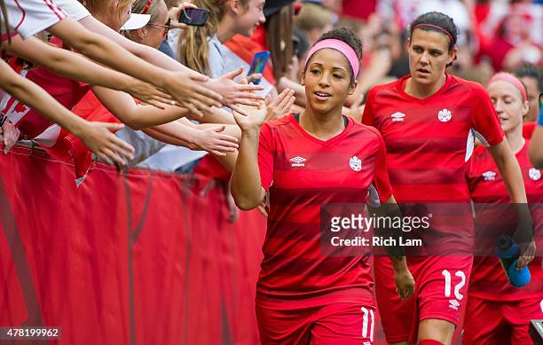 Desiree Scott and Christine Sinclair of Canada high fives fans after the team warmup prior to the start of the FIFA Women's World Cup Canada 2015...