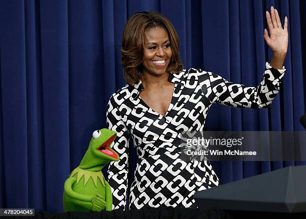 Kermit the Frog is welcomed by U.S. First lady Michelle Obama at a screening of Disney's "Muppets Most Wanted" at the Eisenhower Executive Office...