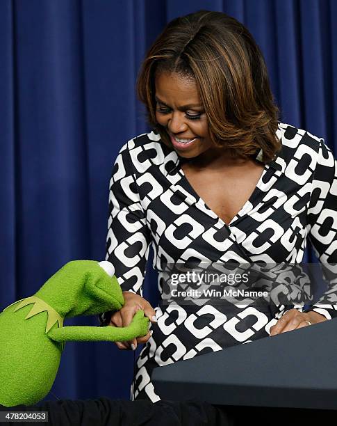 Kermit the Frog kisses the hand of U.S. First lady Michelle Obama at a screening of Disney's "Muppets Most Wanted" at the Eisenhower Executive Office...