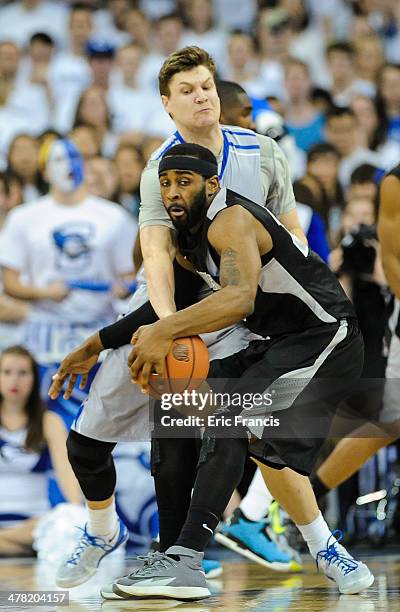 Grant Gibbs of the Creighton Bluejays defends LaDontae Henton of the Providence Friars during their game at CenturyLink Center on March 8, 2014 in...