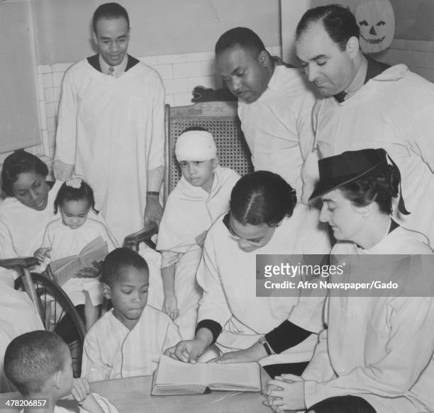 Physically handicapped children receive schooling at Freedmen's Hospital, Washington DC, 1935. Pictured are, from left, James Moore, John Pinkney,...