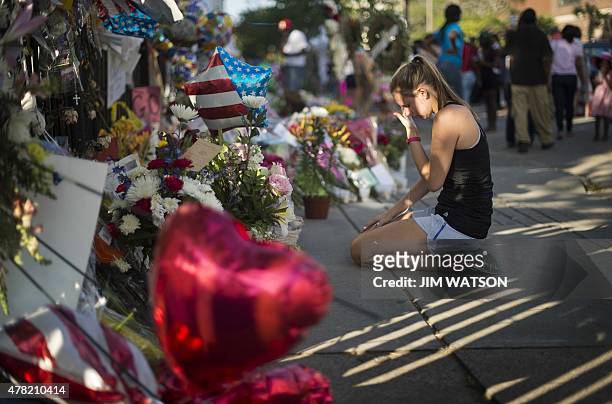Local resident Meredith wipes away a tear after praying outside Emanuel AME Church in Charleston, South Carolina, on June 23, 2015. Police captured...