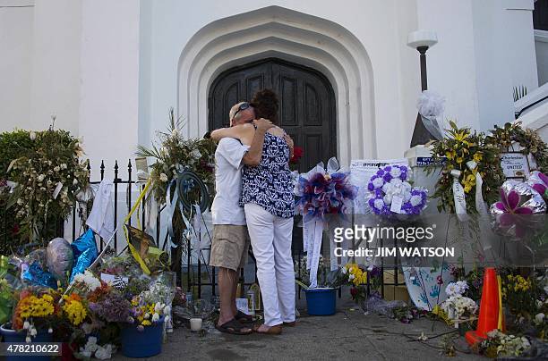 Steve Kent hugs his wife Kim as they share a moment outside Emanuel AME Church in Charleston, South Carolina, on June 23, 2015. Police captured the...