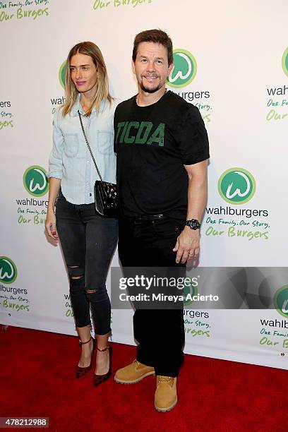 Model Rhea Durham and actor Mark Wahlberg attend the Wahlburgers Coney Island VIP Preview Party at Wahlburgers Coney Island on June 23, 2015 in New...