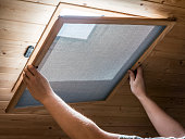 Installing homemade mosquito net on velux window on ceiling