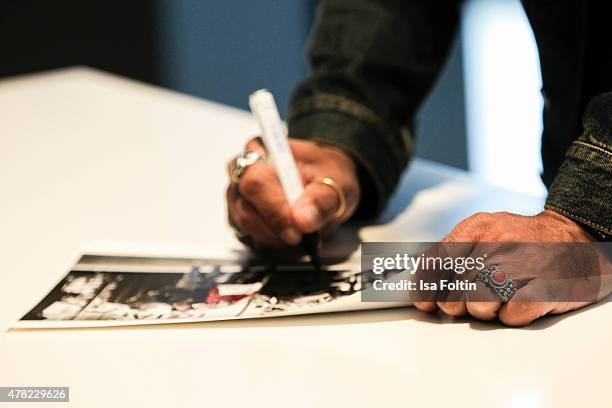 Lenny Kravitz signs his books during the vernissage 'Flash by Lenny Kravitz' on June 23, 2015 in Wetzlar, Germany.