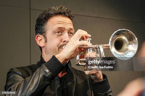 Till Broenner plays the trumpet during the vernissage 'Flash by Lenny Kravitz' on June 23, 2015 in Wetzlar, Germany.