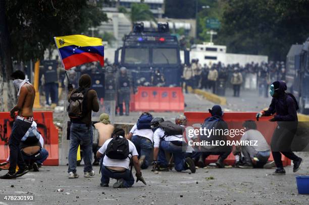 Venezuelan students and activists clash with riot police during a protest against the government of President Nicolas Maduro, in Caracas on March 12,...