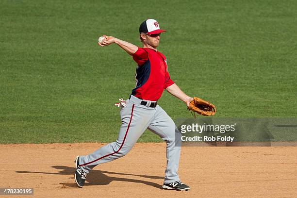 Mike Fontenot of the Washington Nationals throws to first base during the spring training game against the Houston Astros at Osceola County Stadium...