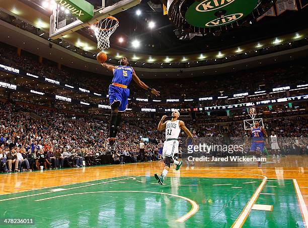 Tim Hardaway, Jr of the New York Knicks dunks the ball against the Boston Celtics in the second quarter during the game at TD Garden on March 12,...