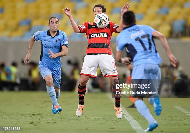 Elano of Flamengo battles for the ball against Jose Luis Sanchez Capdevila and Juan Carlos Arce of Bolivar during a match between Flamengo and...