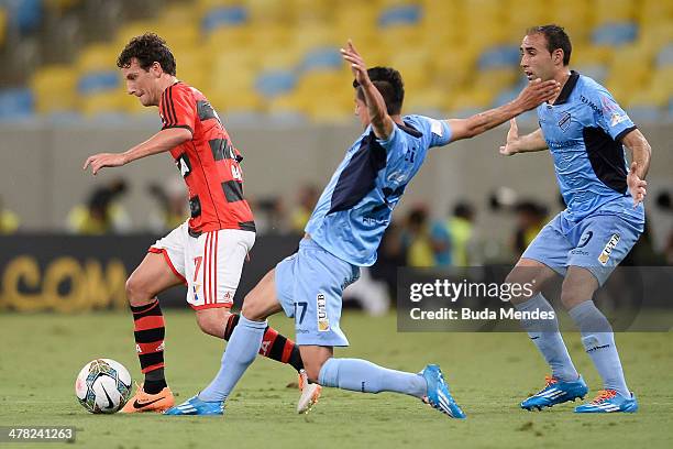 Elano of Flamengo battles for the ball against Jose Luis Sanchez Capdevila and Juan Carlos Arce of Bolivar during a match between Flamengo and...