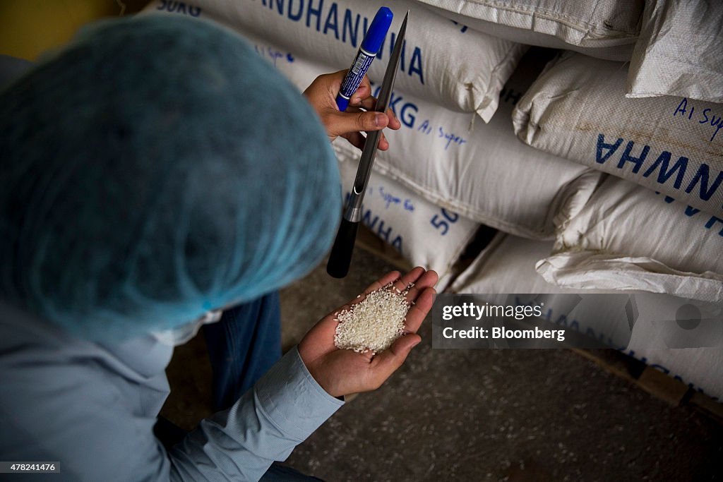 Amru Rice A worker inspects rice at the Amru Rice Co. processing factory in ...