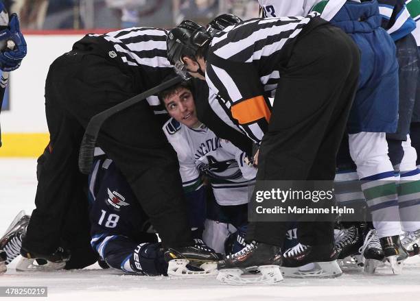 Alexandre Burrows of the Vancouver Canucks looks up to officials after a tussle with Bryan Little of the Winnipeg Jets in second-period action in an...