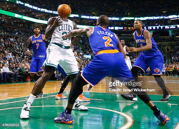 Brandon Bass of the Boston Celtics attempts to grab a rebound in front of Raymond Felton of the New York Knicks in the second half during the game at...