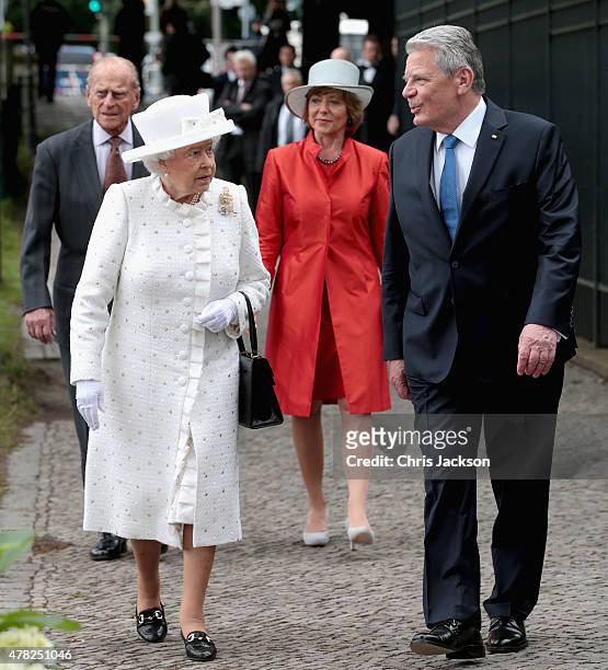 Queen Elizabeth II and Prince Philip, Duke of Edinburgh walk to the bank of the River Spree to travel by boat to the Chancellery with Germany...