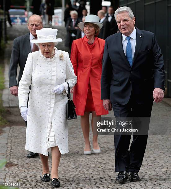Queen Elizabeth II and Prince Philip, Duke of Edinburgh walk to the bank of the River Spree to travel by boat to the Chancellery with Germany...