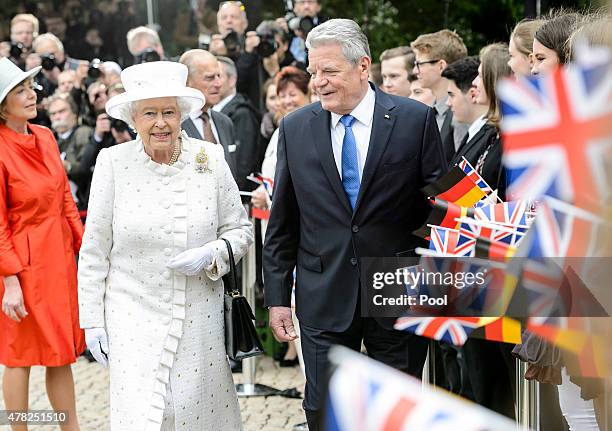Queen Elizabeth II and German President Joachim Gauck meet pupils outside Schloss Bellevue Palace on the second day of a four day State visit to...