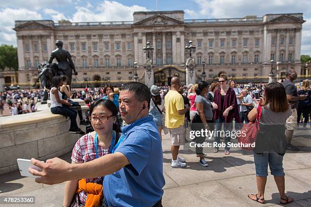 Tourists take a selfie in front of Buckingham Palace on June 24, 2015 in London, England. The Queen may have to move out of Buckingham Palace, her...