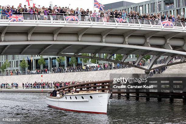 German President Joachim Gauck, his partner Daniela Schadt, Queen Elizabeth II and Prince Philip, the Duke of Edinburgh, ride a boat on the Spree...