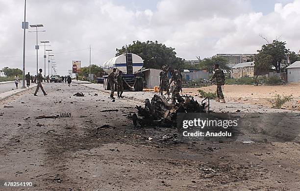 Members of the Somalian security forces patrol at the scene after a car bombing attack on United Arab Emirates embassy convoy, killed seven and...