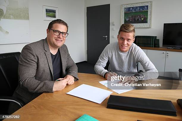 Director of Sport Max Eberl and Nico Elvedi of Borussia Moenchengladbach during signing a new contract for Borussia Moenchengladbach on June 24, 2015...