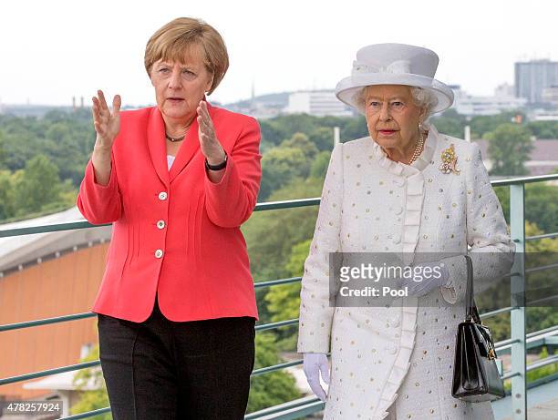 German Chancellor Angela Merkel welcomes Queen Elizabeth II upon her arrival at the Federal Chancellery on the second of the royal couple's four-day...